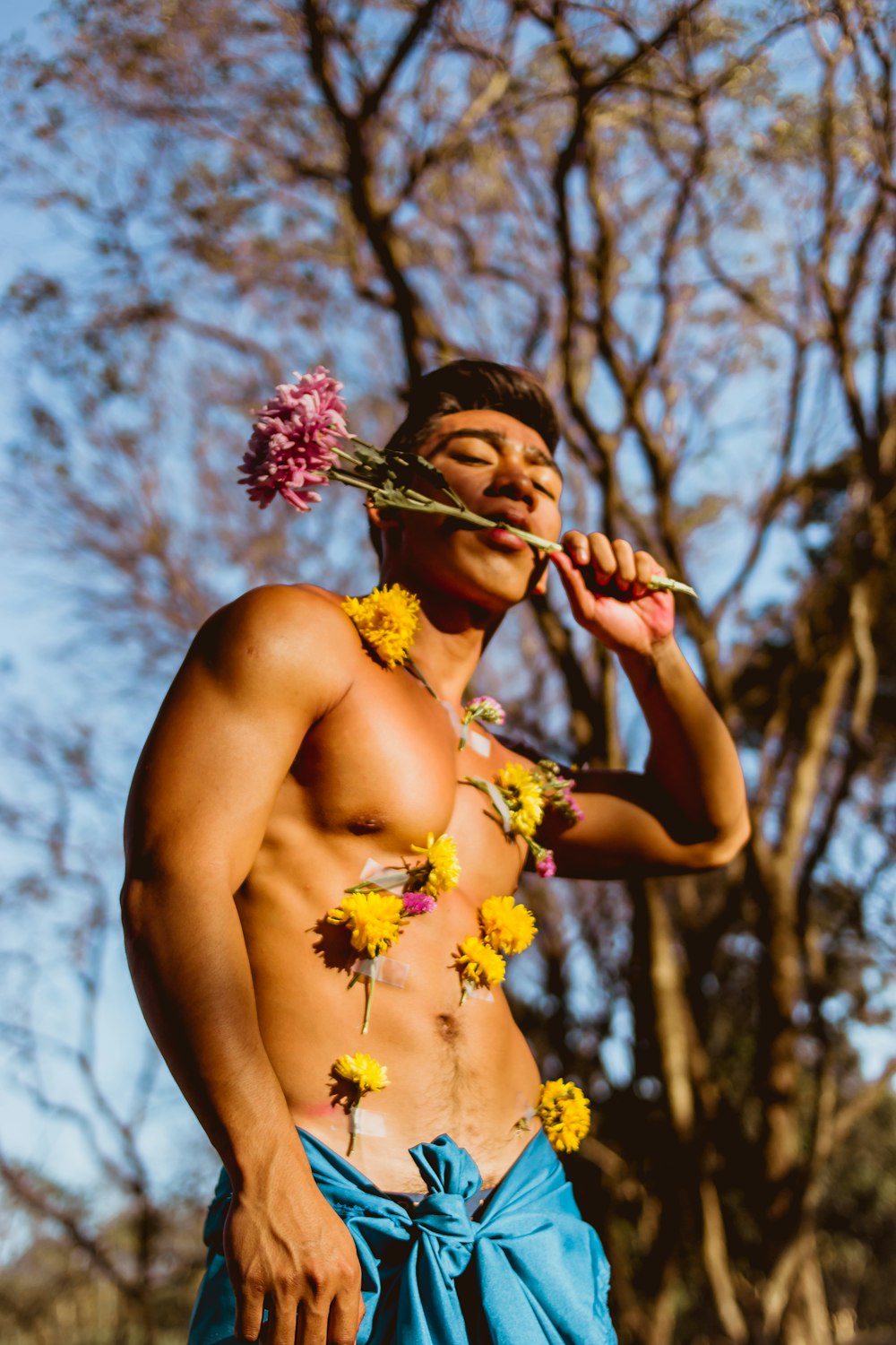 man biting flower stem