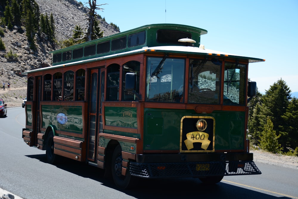 brown and green bus on road at daytime