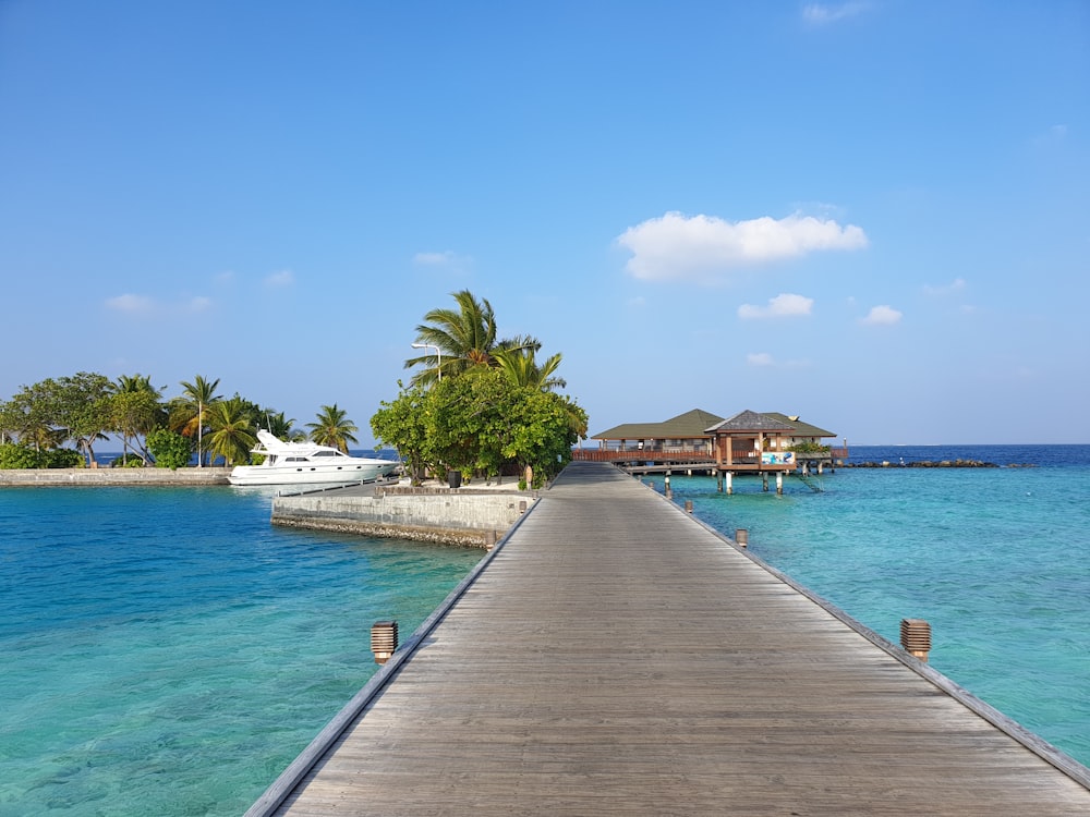 yacht on dock near resort at daytime