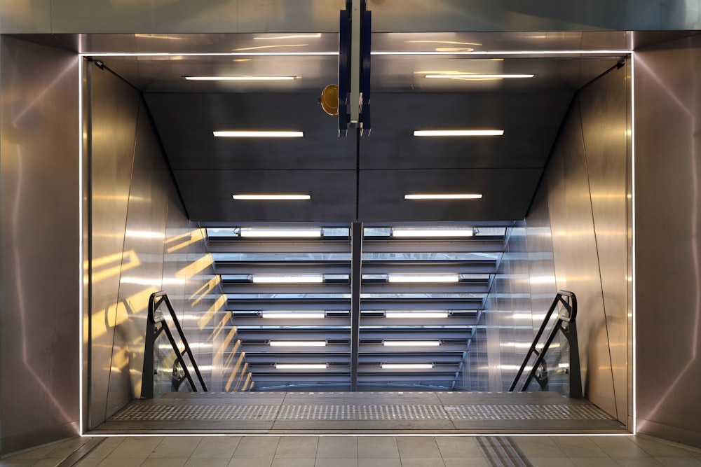 a metal elevator with stairs leading up to it