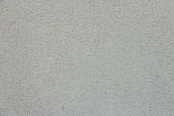 Neutral-toned textured wall with subtle architectural patterns reflecting professionalism.