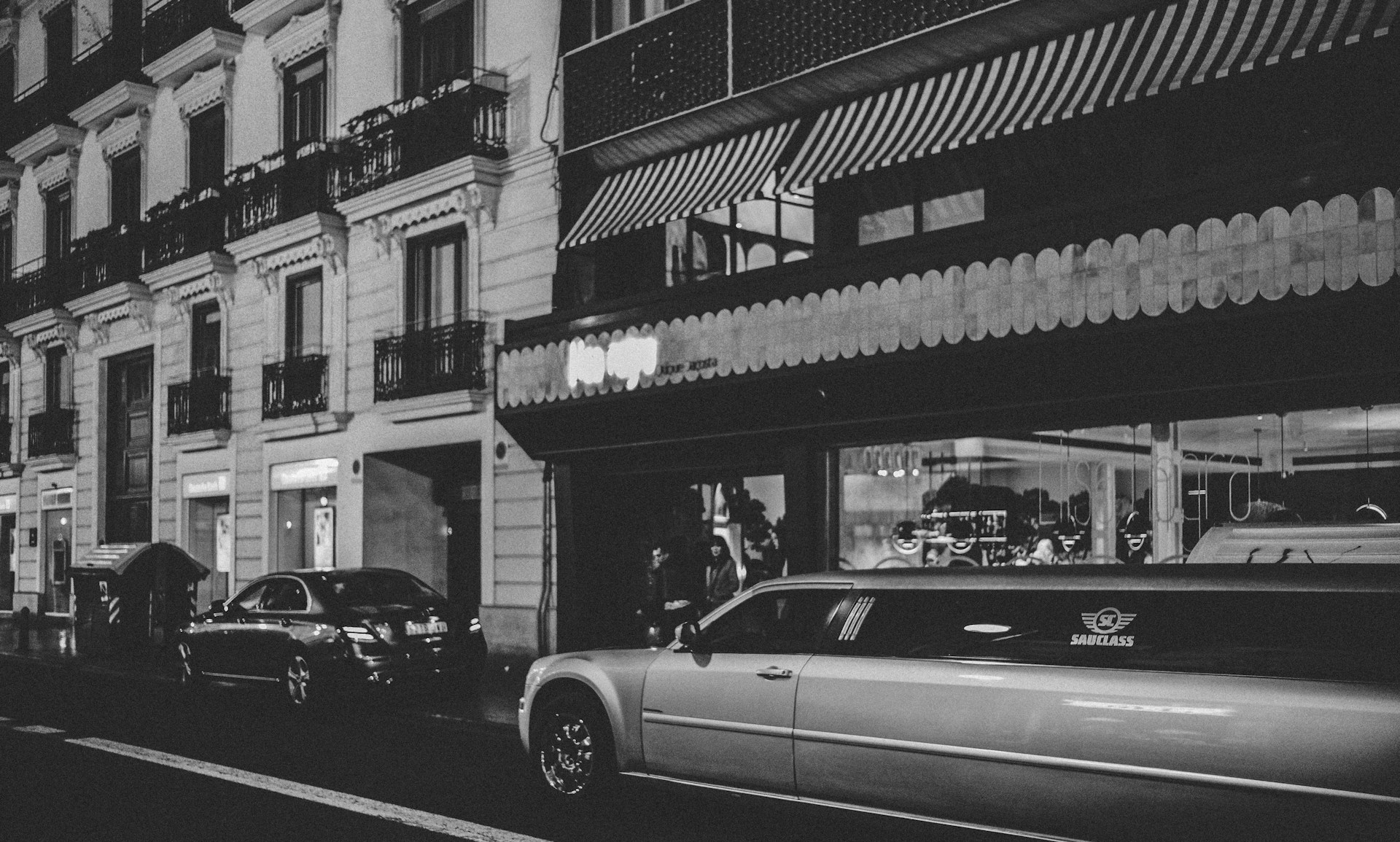 grayscale photo of vehicles on roadway