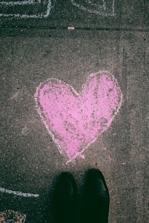 person near sketch of pink heart