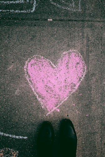 person near sketch of pink heart