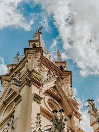 A historic building with ornate architecture and a blue sky.