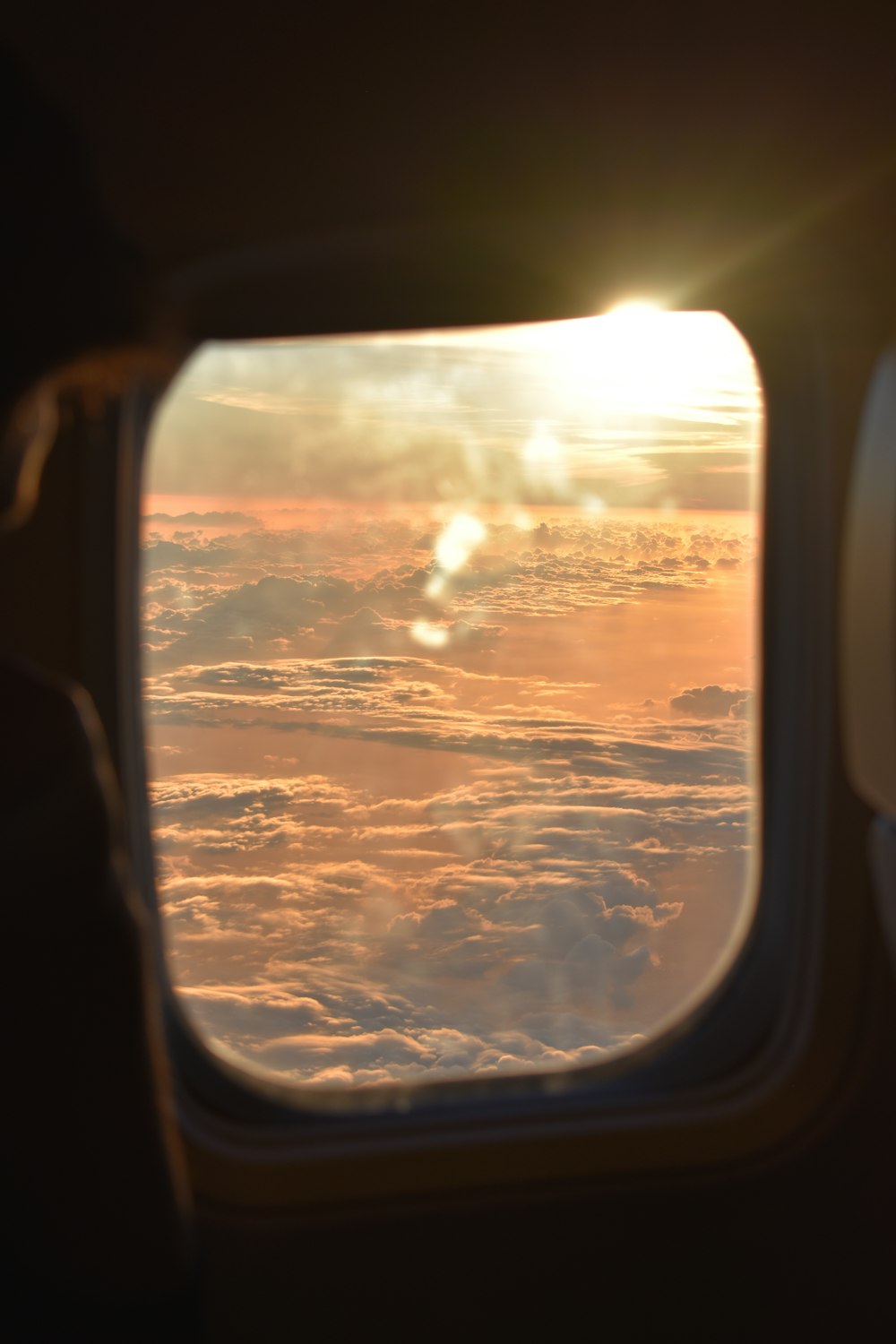 the view out of an airplane window at sunset