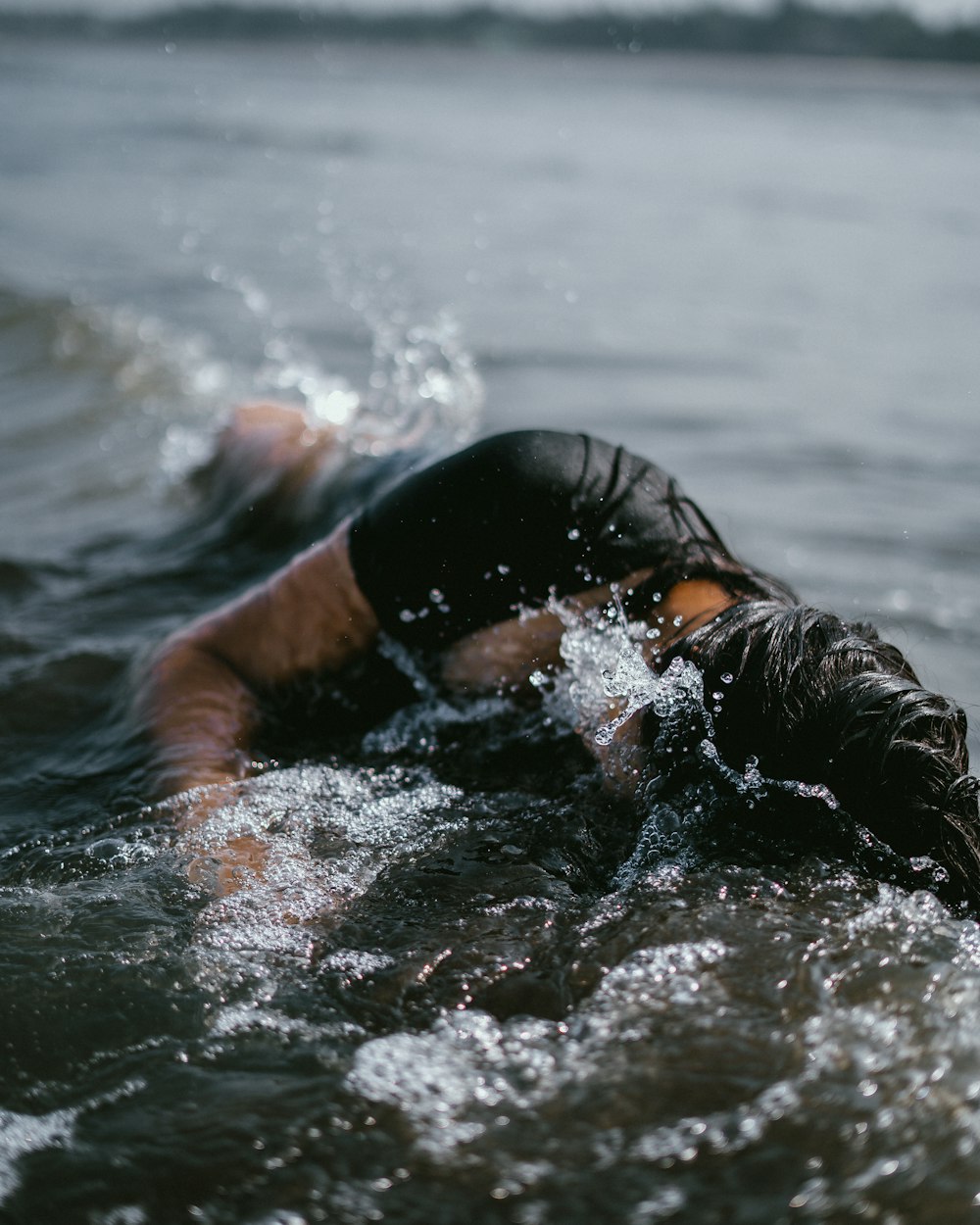 woman half submerge on body of water