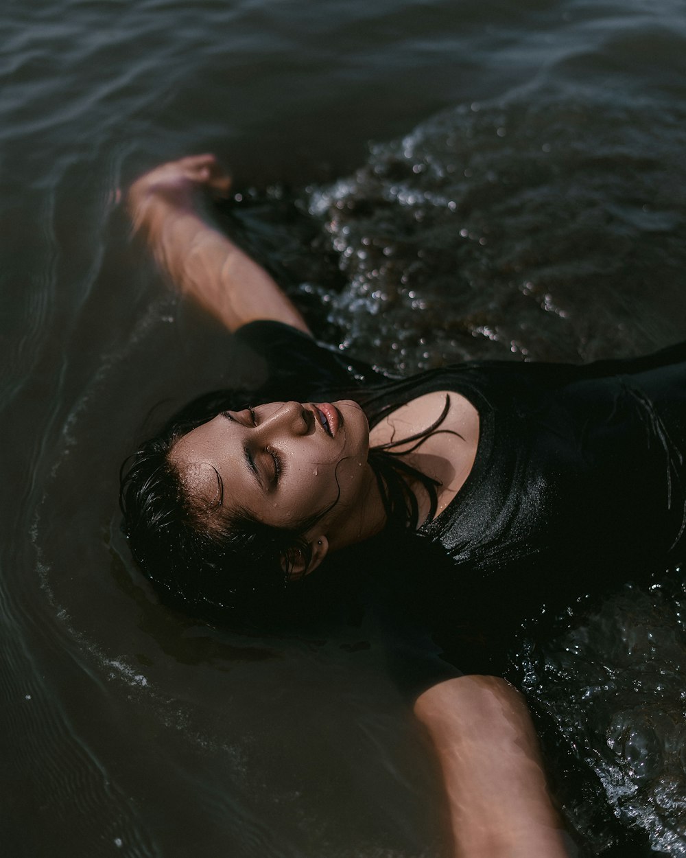 woman wearing black top in body of water