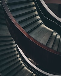 A completed staircase with sleek, modern wood design glowing in warm sunlight.