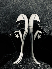 A stylish pair of classic All Star sneakers on a vibrant urban sidewalk.