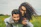 woman riding on man's back on green field