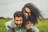 woman riding on man's back on green field