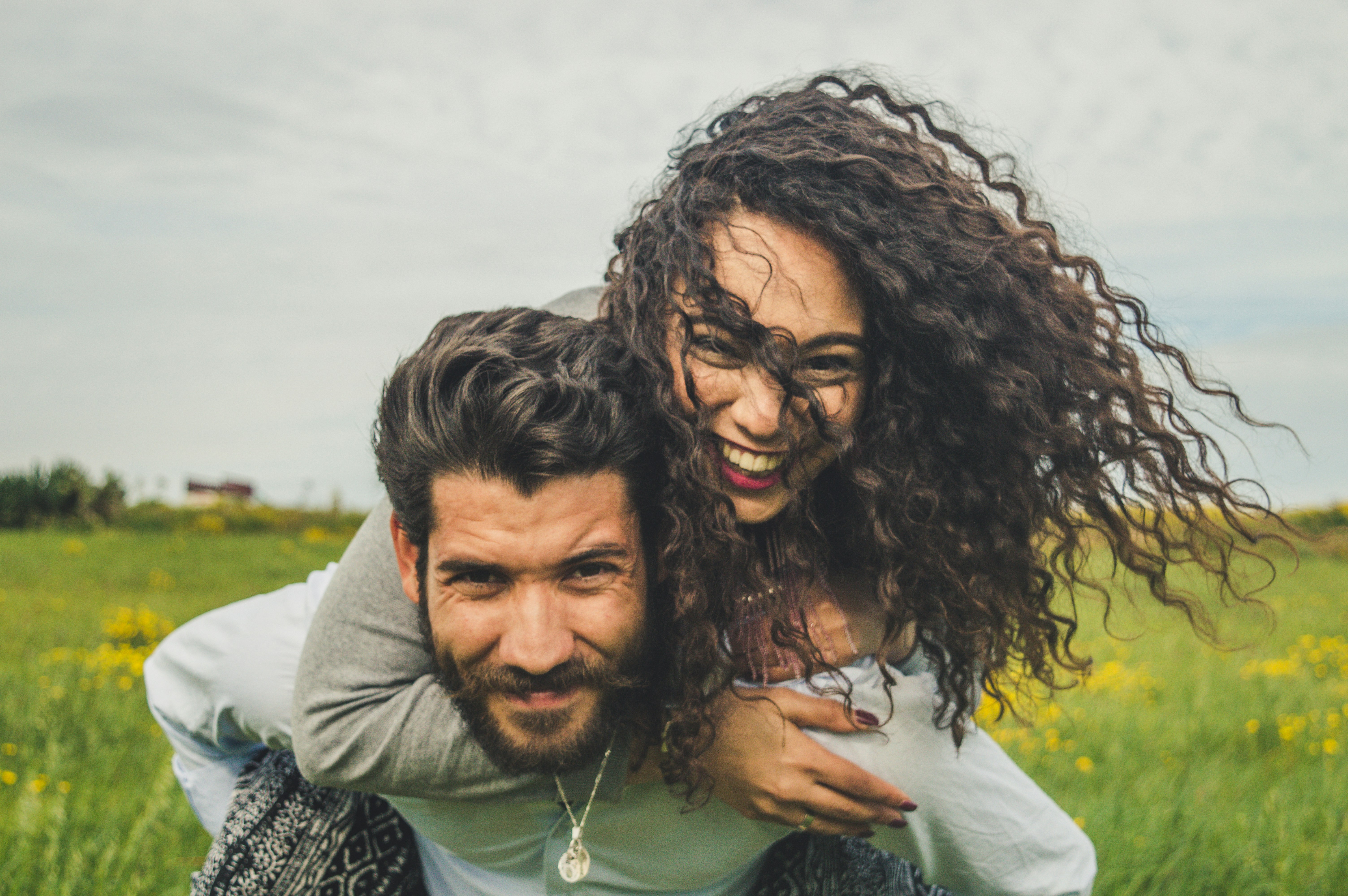 great photo recipe,how to photograph woman riding on man's back on green field