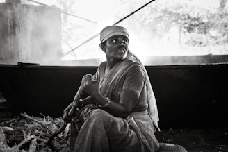 A warm kitchen scene showing women farmers carefully preparing traditional Nepali pickles in small batches.