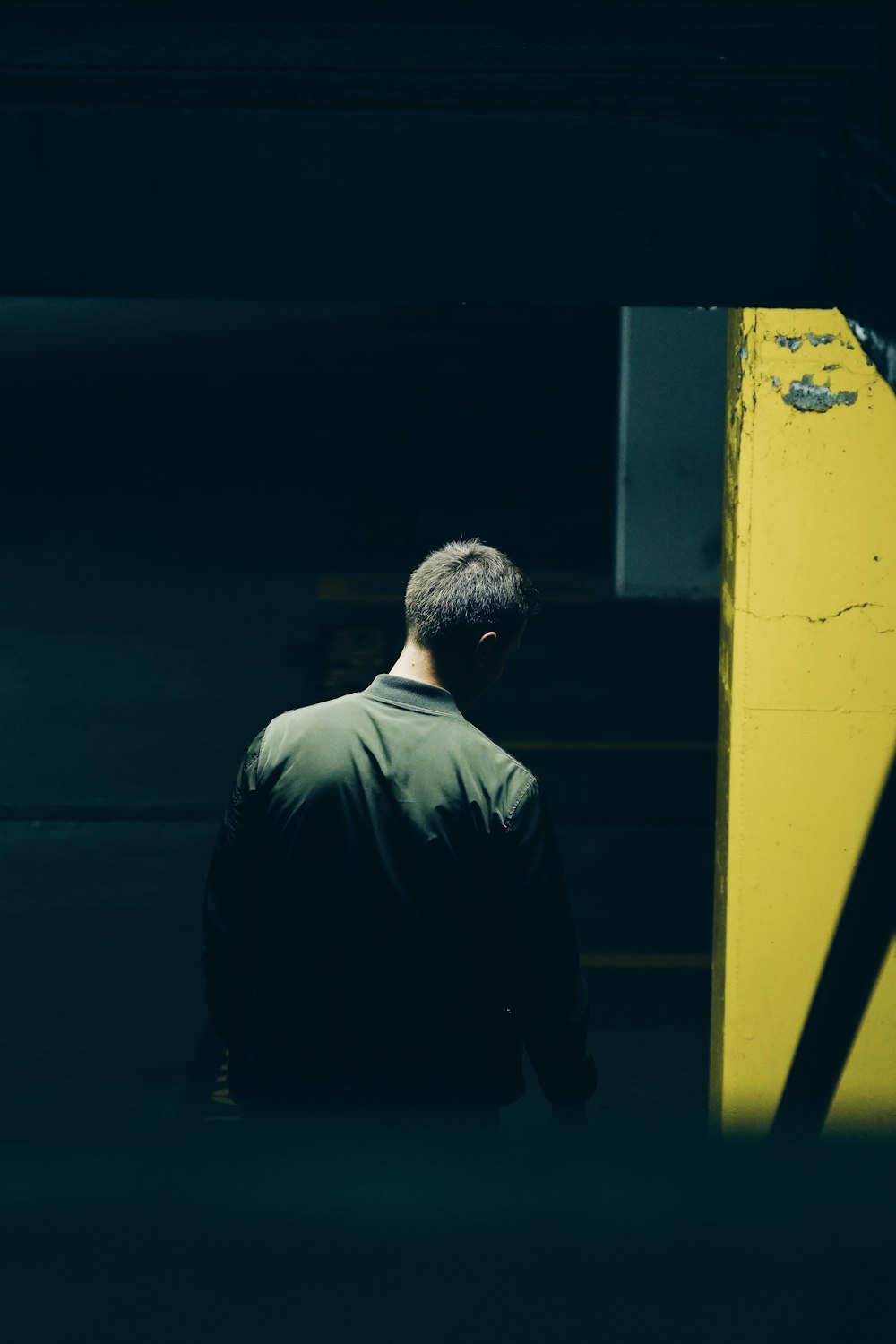 man in black top near yellow furnituer