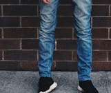 man in blue denim jeans standing