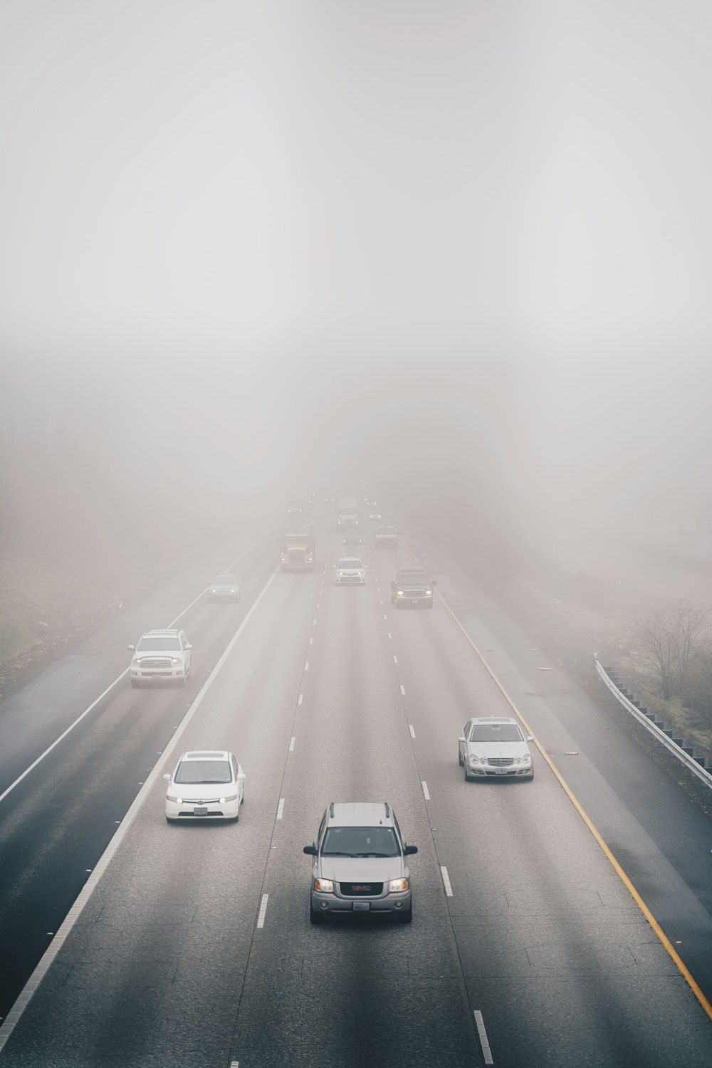 a foggy highway filled with lots of traffic
