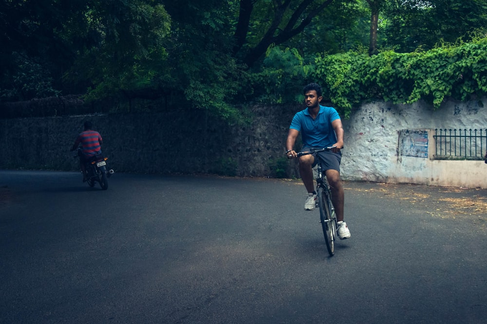 man cycling on road