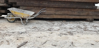 A rugged wheelbarrow loaded with construction materials on site.
