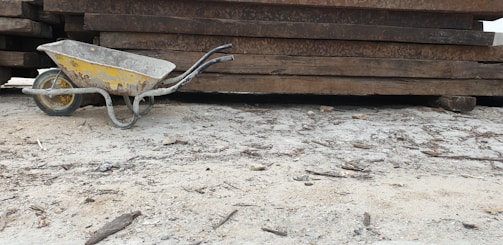 A rugged wheelbarrow loaded with construction materials on site.