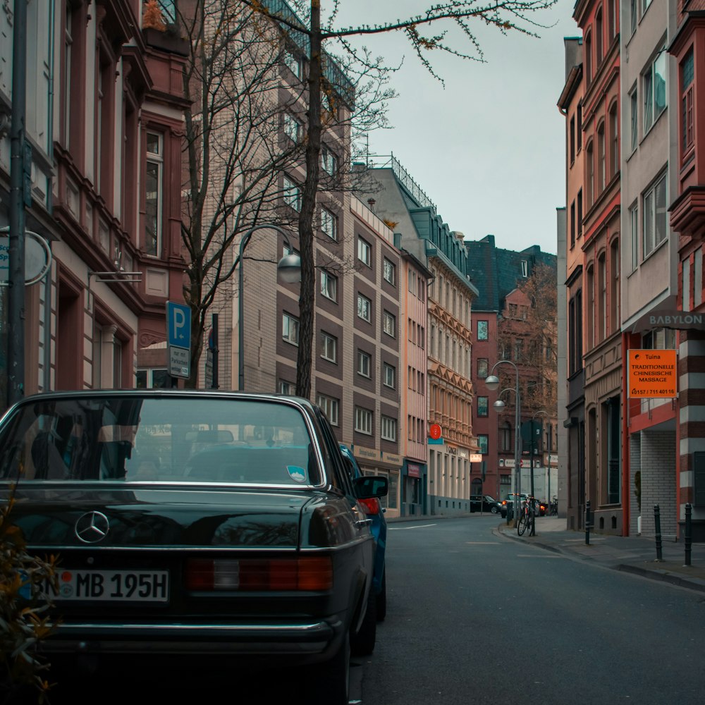 black Mercedes-Benz vehicle parked near concrete building