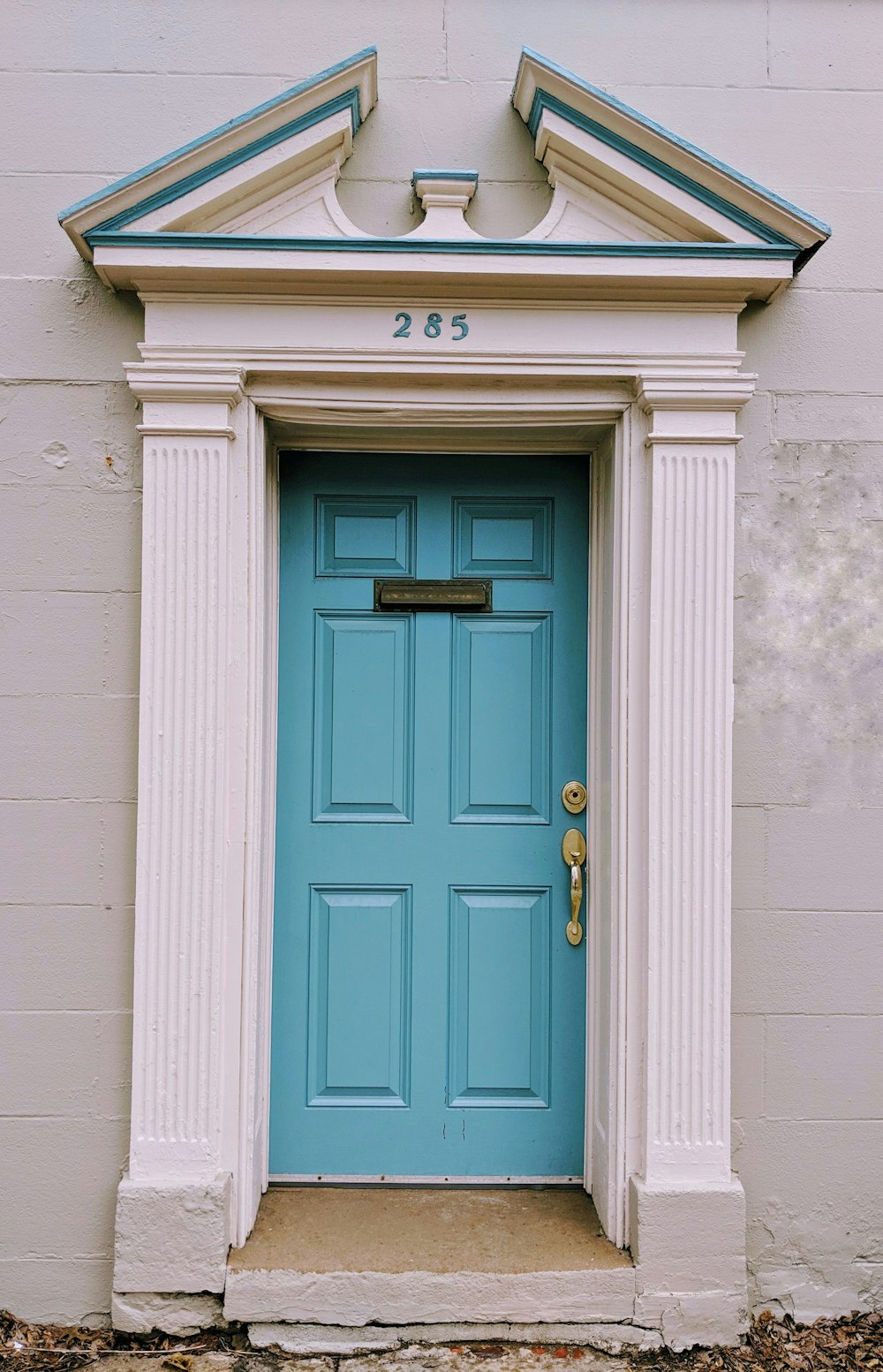 a blue front door of a white building
