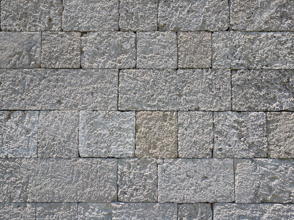 a close up of a wall made of stone blocks