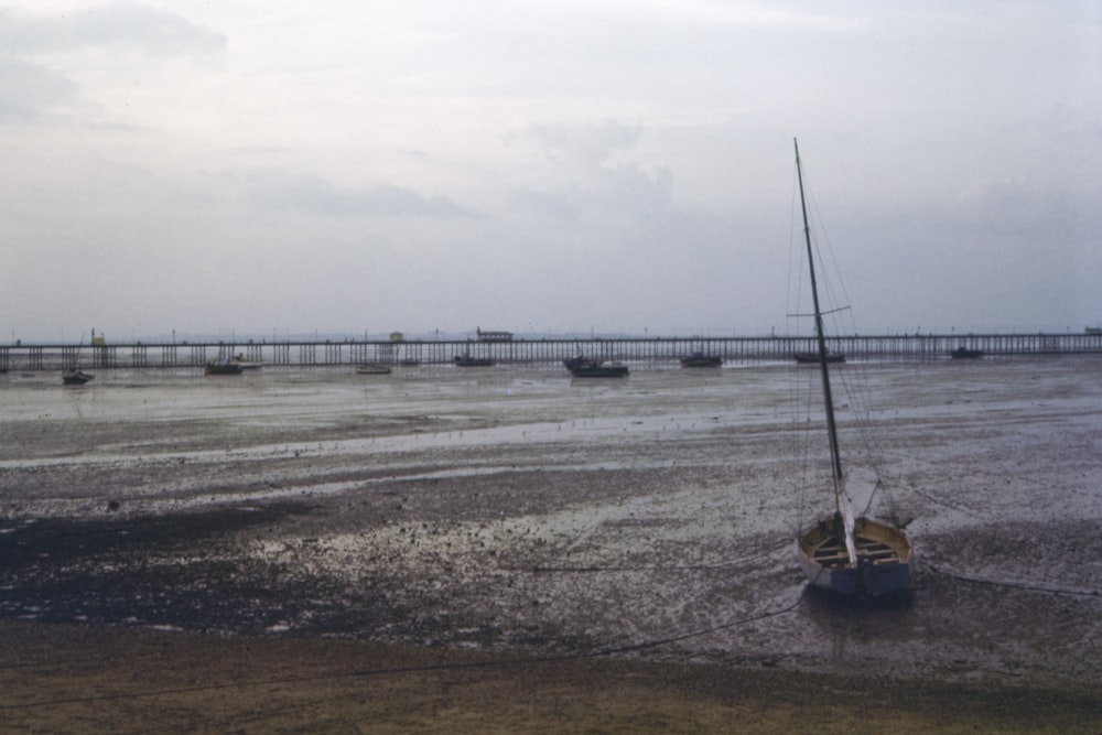 gray sailboat on shore