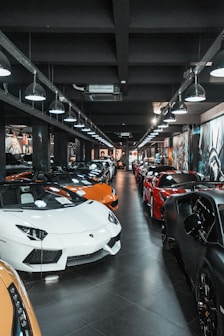 different luxury cars parking inside building