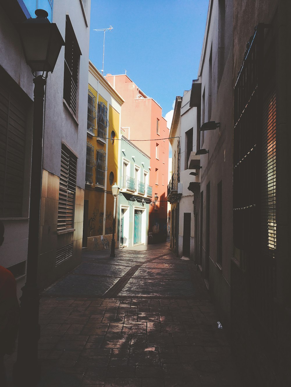 pathway in between multicolored concrete buildings