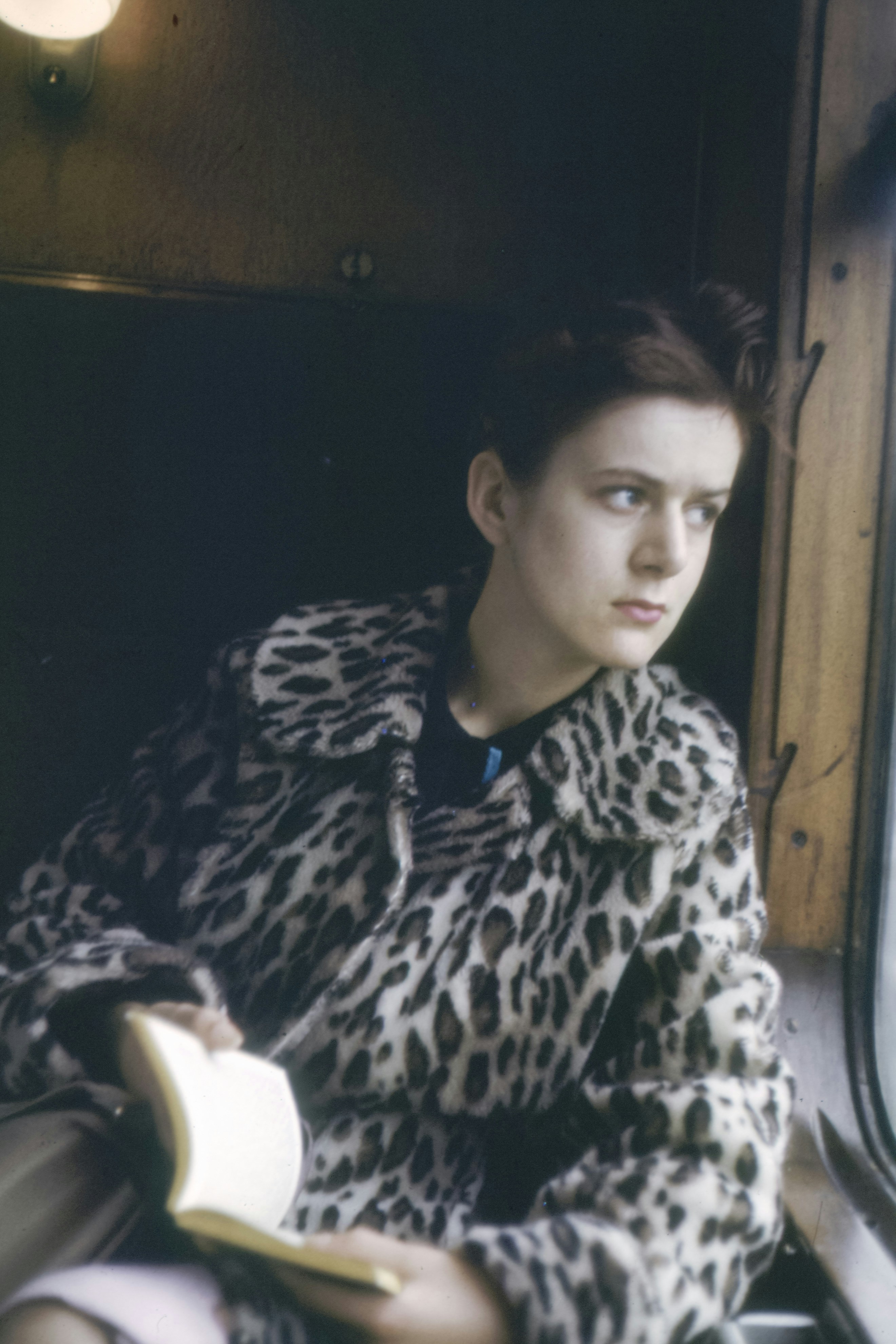 woman wears brown and white leopard print coat