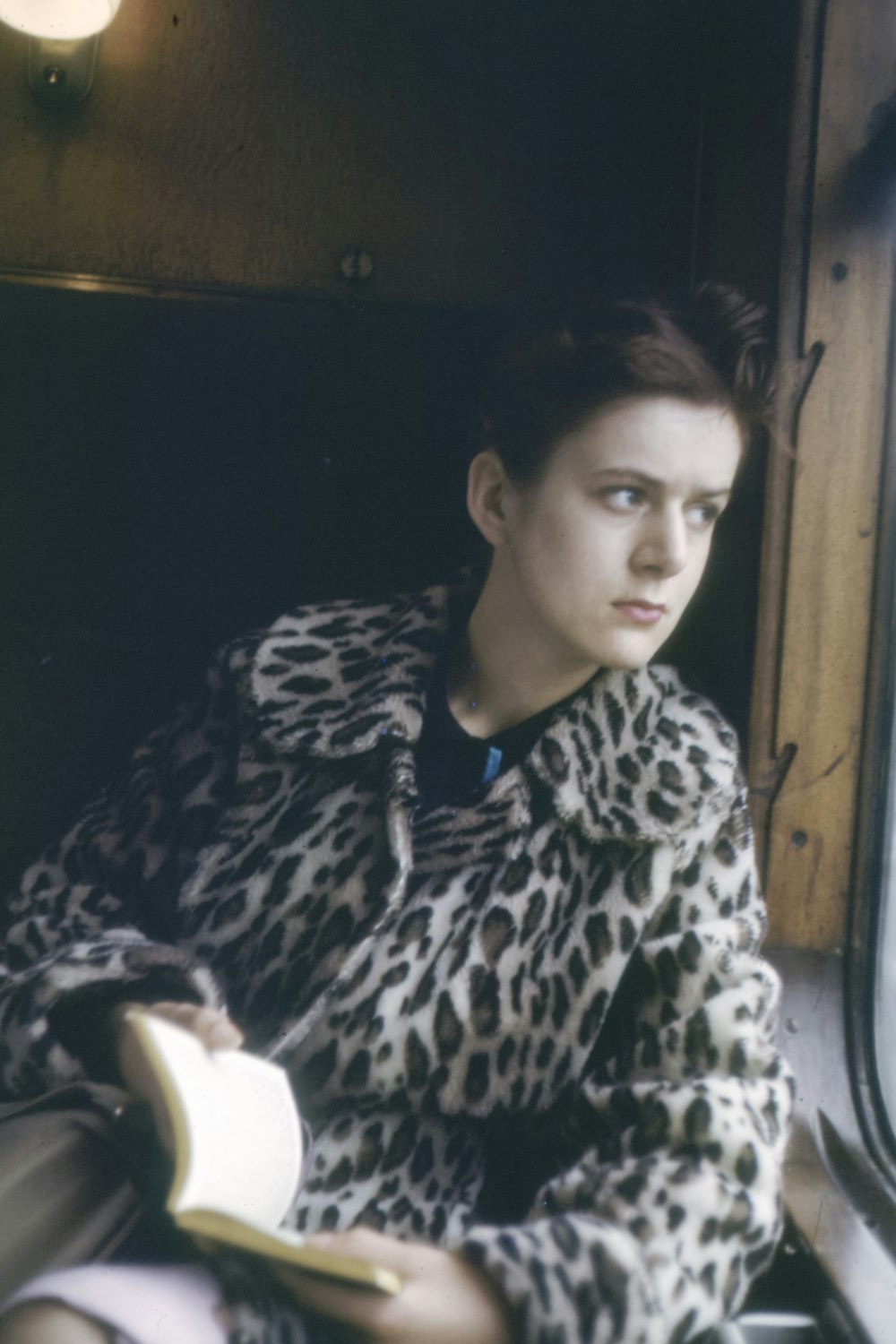 woman wears brown and white leopard print coat