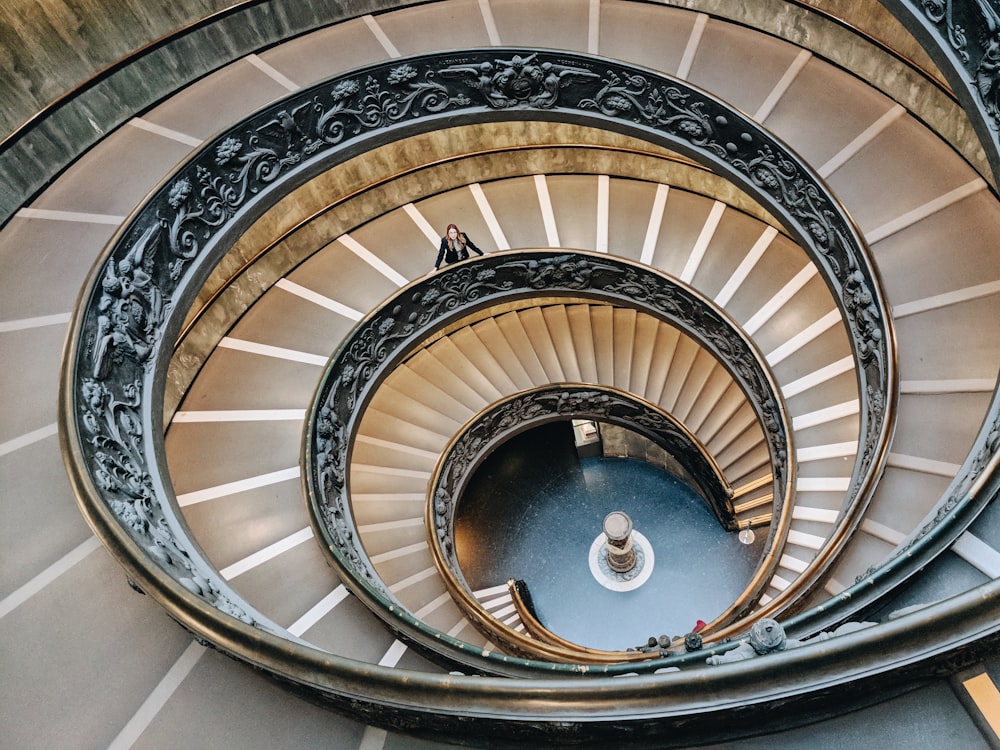 brown spiral staircase with brown wooden railings