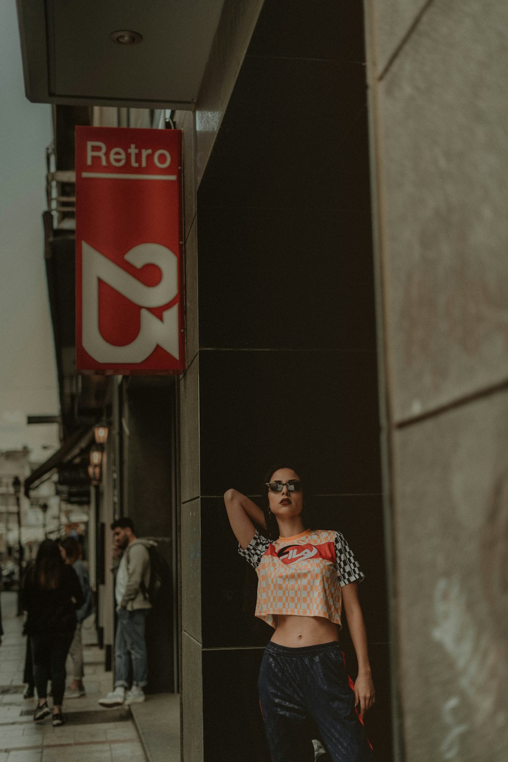 woman in crop top standing by door