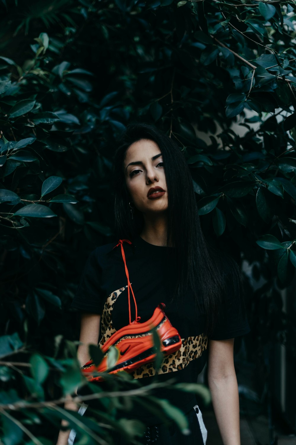 woman standing near green trees