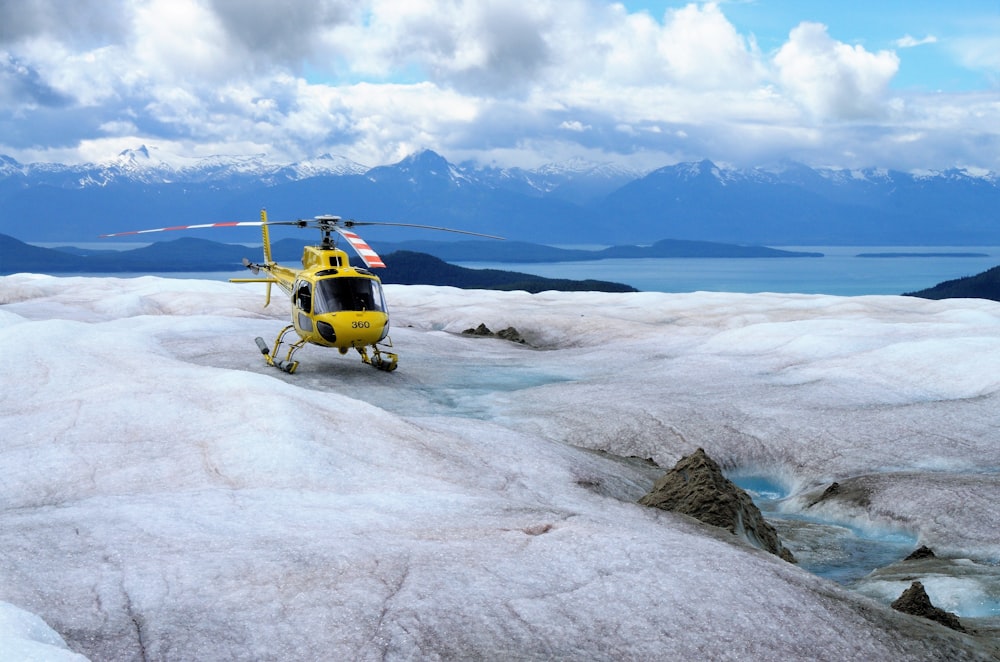 yellow helicopter on mountain