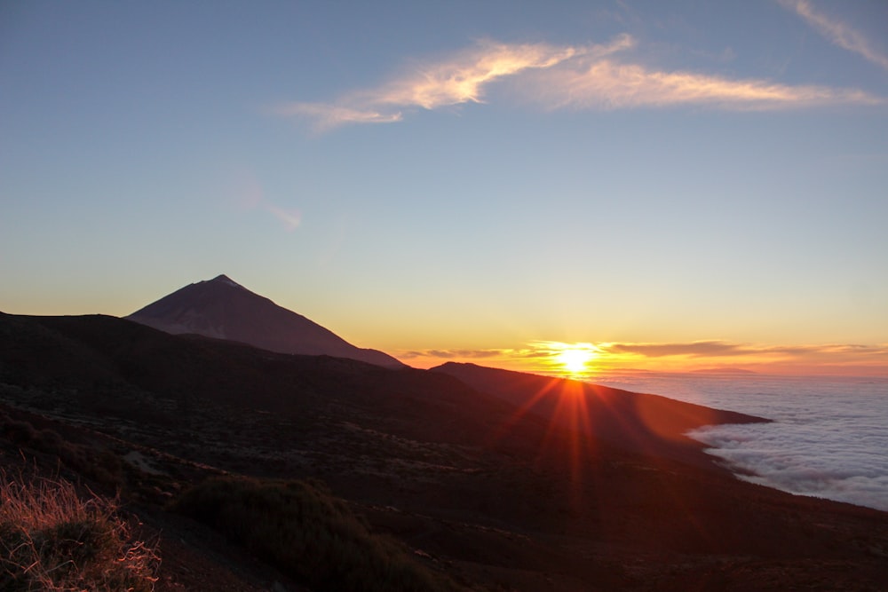 silhouette mountain during sunset