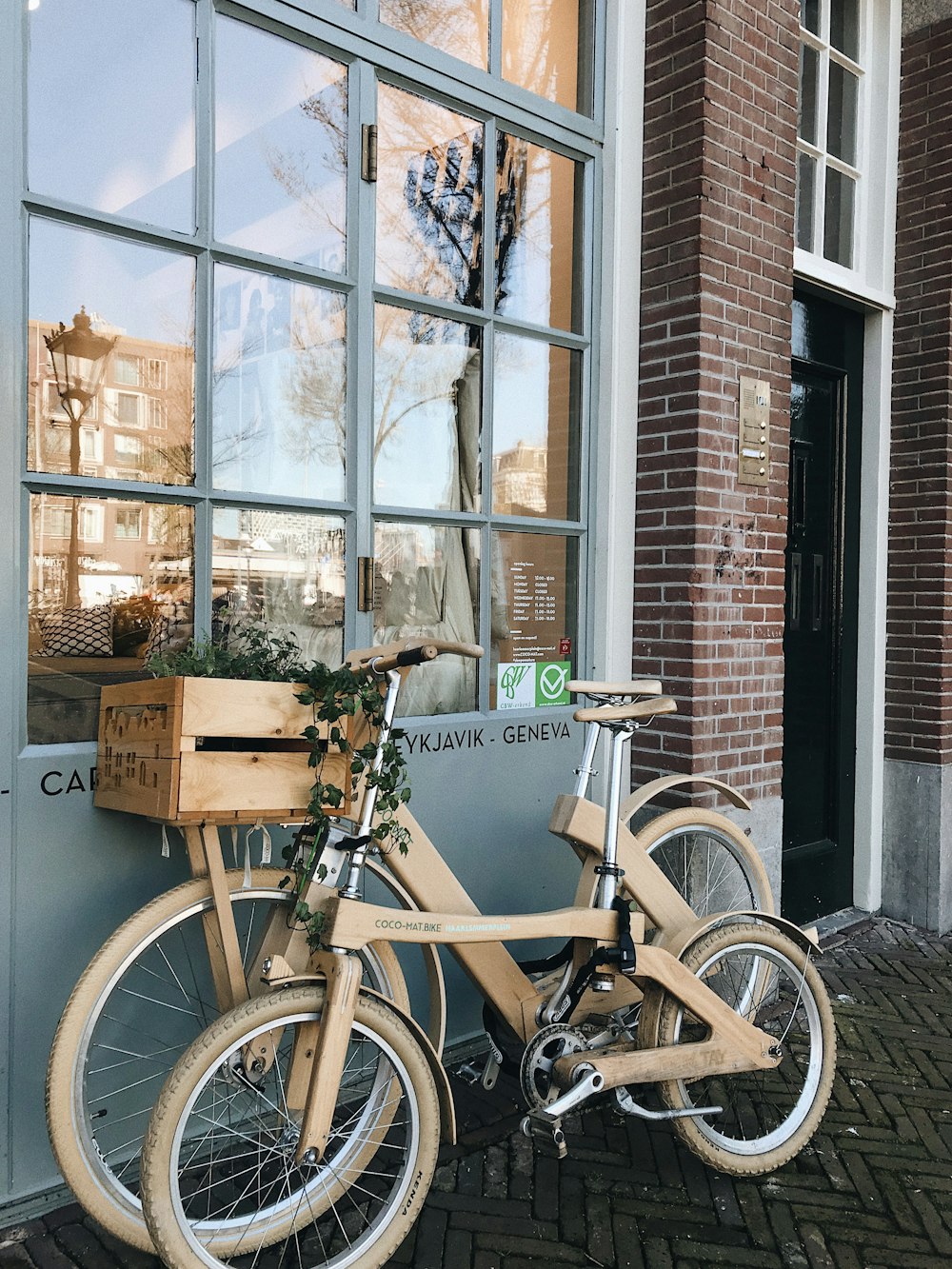 black and gray commuter bike parked beside brown wooden box