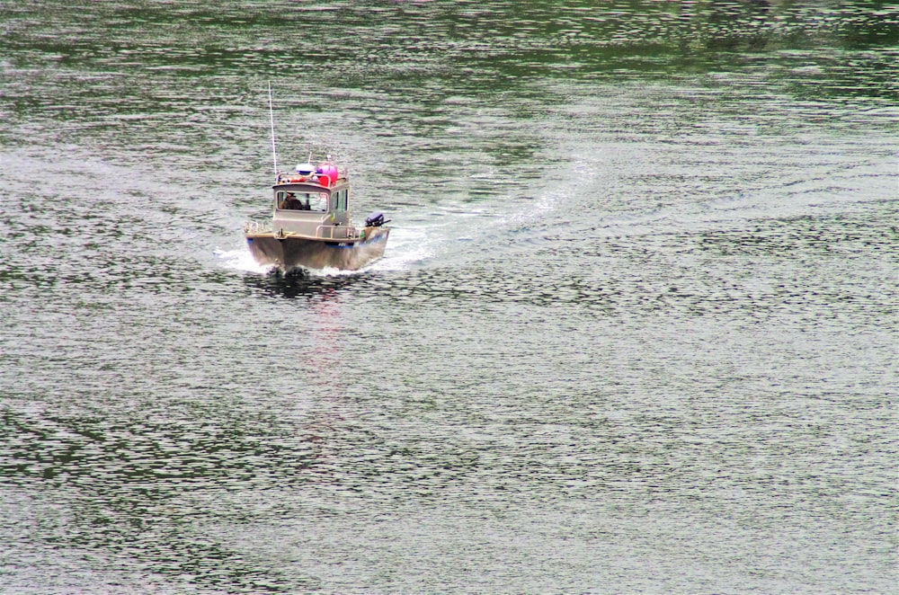 brown speedboat on water