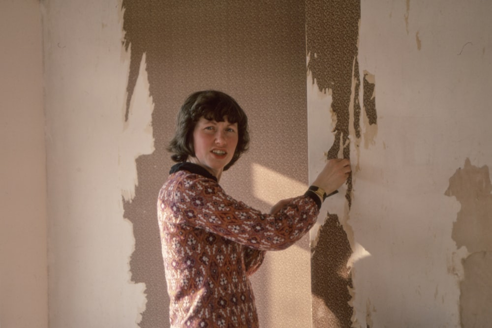 woman standing near brown wall