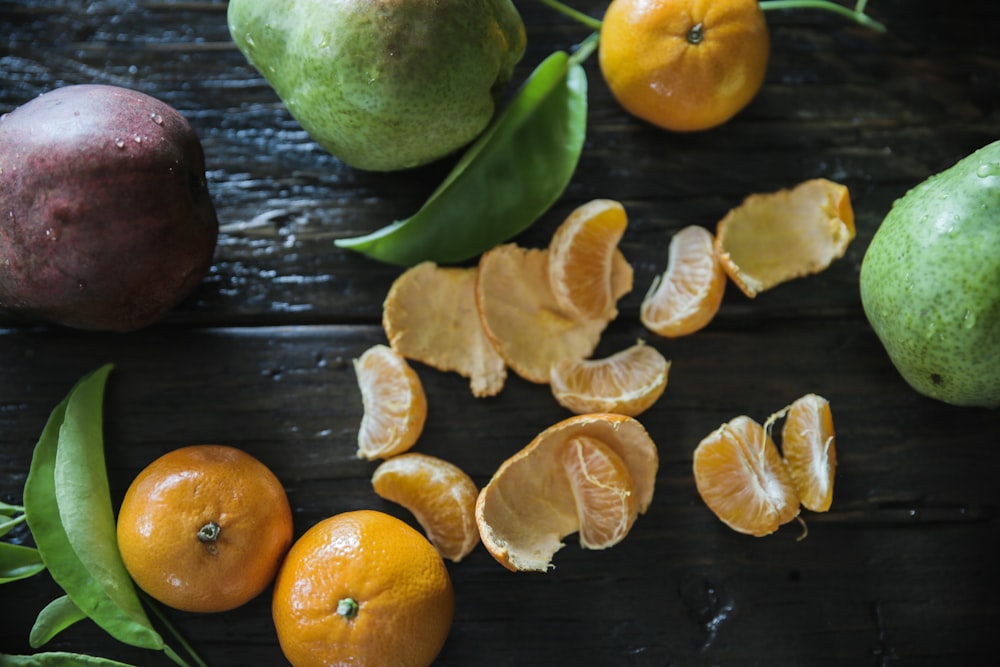 peeled oranges on table surround with other fruits
