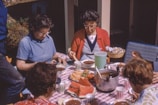 women sitting beside table