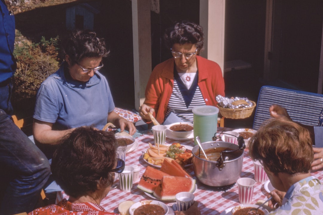 women sitting beside table