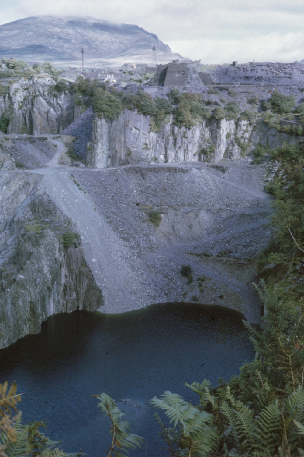 body of water beside mountain during daytime