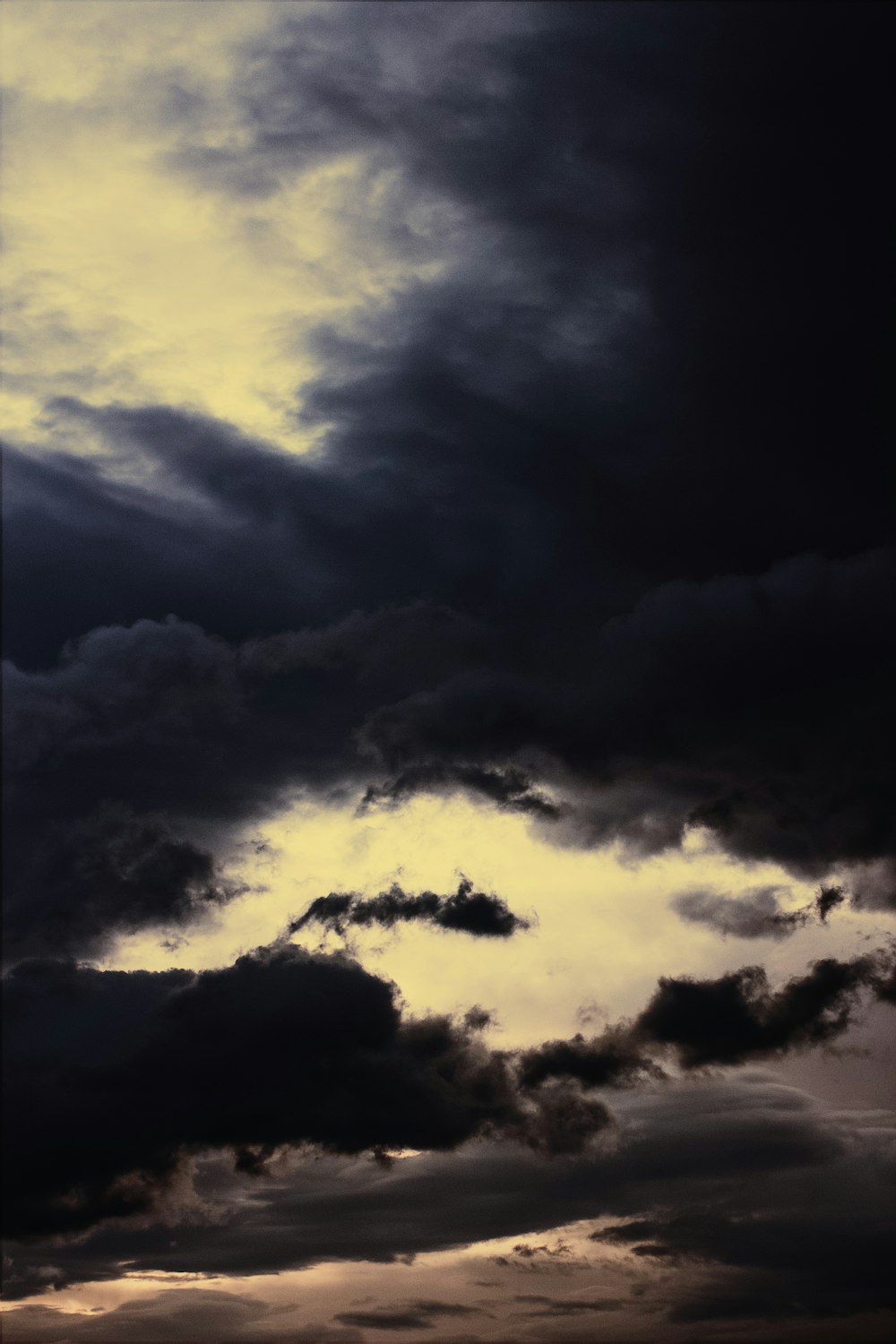 a plane flying through a cloudy sky on a cloudy day