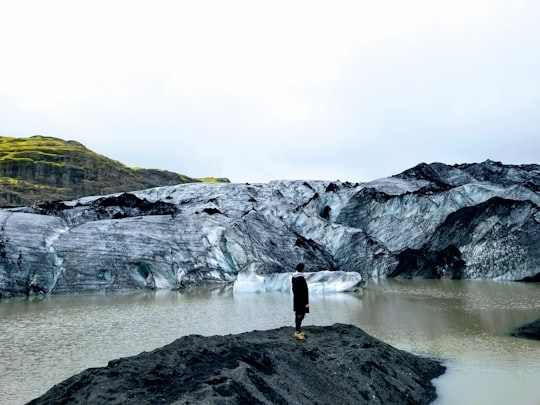 person standing on rock in Southern Region Iceland