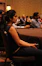 A woman attentively participating in an online investment training session.