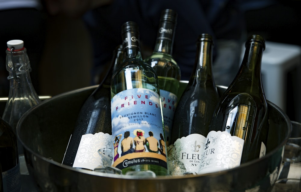 blue labeled bottles in bucket