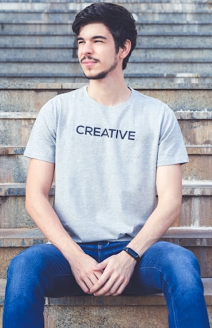 man sitting on concrete stairs