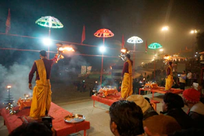 A night ceremony with indigenous leaders, glowing fires, and attentive participants.